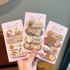 Close-up of cute cartoon embroidered hair clips with bears and flowers for girls
