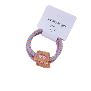 Cute pink and blue braided elastic hair tie with a rainbow heart fabric patch on card