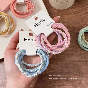 Detailed view of colorful twisted woven elastic hair bands in macaron colors on a card