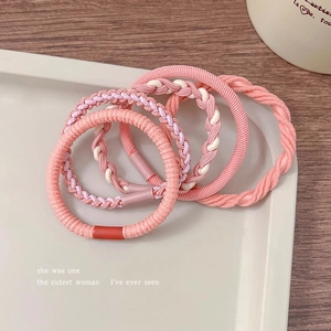 Detailed close-up of 5pcs pink elastic hair ties with woven and twisted knit textures