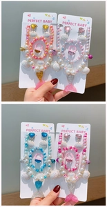 Detail view of handmade mermaid tail jewelry set with colorful shell and pearl beads