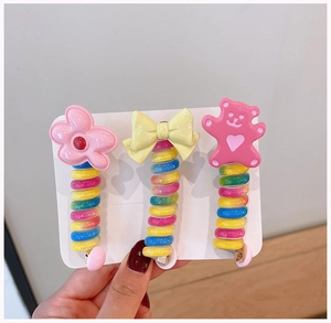 Detail of candy color spiral hair clips with flower, bow and bear shapes on display card
