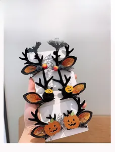 Detail of Halloween hair clips featuring black antlers, pumpkins and bats on card