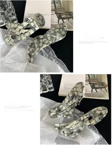 Detail of checkered acetate hair clips featuring modern wavy and rectangular designs