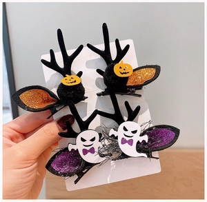 Detailed close-up of Halloween hair clips with reindeer antlers, pumpkin and ghost motifs