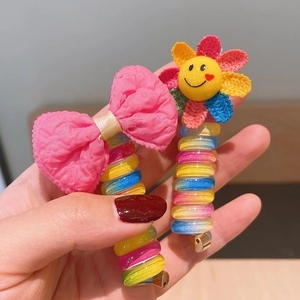 Rainbow spiral hair ties set with pink fabric bow and colorful sunflower smile charms