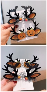 Detail of Halloween hair clips with glitter pumpkins, black antlers and bats on a card
