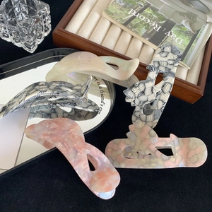 Chic iridescent acetate hair claws in marble and floral patterns for elegant styling