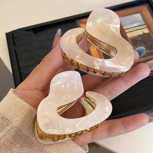 Irregular pearlescent acetate hair claw clips with gold metal base for women's hairstyle