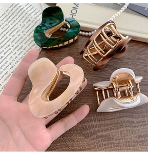 Detailed set of four irregular heart-shaped acetate hair claws in diverse elegant patterns
