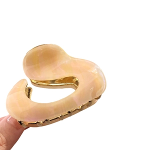 Irregular marble acetate hair claw clip with golden metal base for elegant women