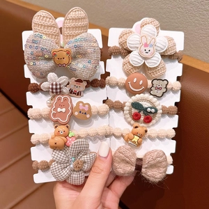 Cute coffee-colored hair ties set with flowers, bears, and bows on display cards