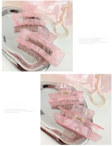 Detailed comparison of pink acetate hair claws with marble texture on metal tray