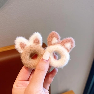 Detail showing the plush knitted texture of cute 3D cat ear hair ties in beige and white