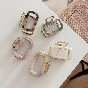 Detail view of 5-piece set of square acetate hair claws with premium marble patterns