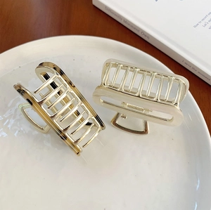Close-up of leopard pattern and cream acetate hair claws on a ceramic plate