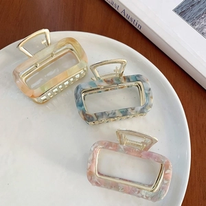 Rectangle hollow acetate hair claws with marble texture in orange, teal and cream colors