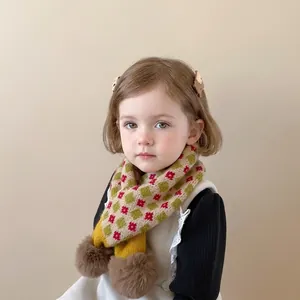 Warm floral knit scarf for kids with yellow green plaid and plush brown pom-poms