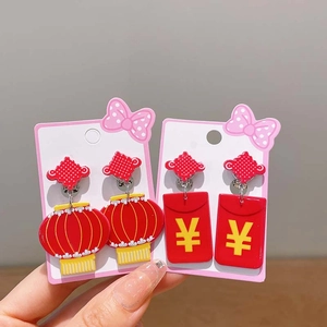 Detailed view of red Chinese lantern and lucky envelope earrings for children on a card