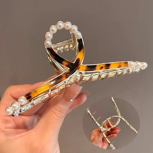 Elegant gold metal hair claw clip with tortoise shell pattern and pearl accents