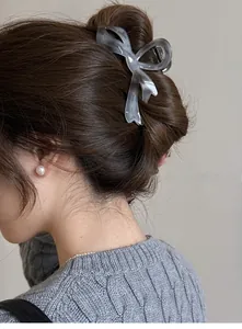 Elegant translucent grey acetate shark clip with marble texture shown on a messy bun