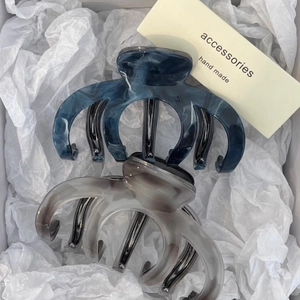 Elegant blue and grey marble acetate shark hair clips displayed in a white gift box