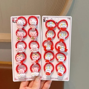 Detail of red elastic hair ties with cute 3D cartoon dragon charms for girls