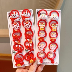 Detailed set of red Chinese New Year hair ties with cute dragon and festive resin charms