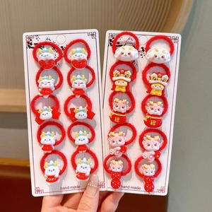 Close-up of red high-elasticity hair ties with 3D cartoon dragon charms for girls
