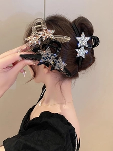 Vue détaillée des pinces à cheveux étoiles avec strass étincelants sur les cheveux