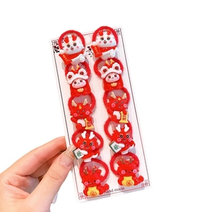 Set of 10 festive red elastic hair ties with cute cartoon dragon resin ornaments
