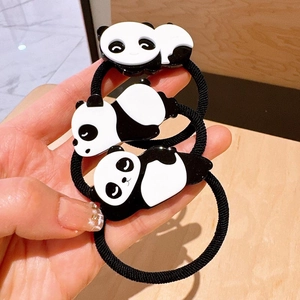 Detailed view of three cartoon panda elastic hair ties with black and white charms