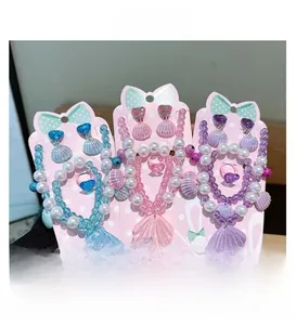 Detailed view of three seashell pearl jewelry sets for girls in blue, pink and purple
