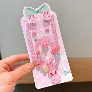 Detailansicht der rosa Acrylperlen-Halskette und Armband-Set mit süßen Hasenanhängern