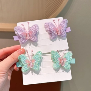 Detail of sweet embroidered butterfly hair clips with delicate mesh and pearl accents