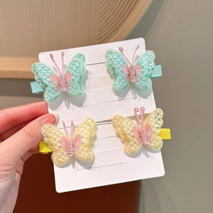 Detailed close-up of 4-piece set embroidered butterfly hair clips with pearls for girls