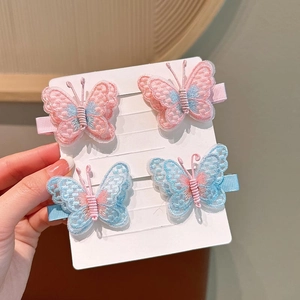 Detailed embroidery butterfly hair clips in pink and blue with lace texture and pearls