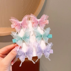 Detailed view of handmade organza butterfly hair clips with pearls and fabric-wrapped base