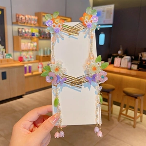 Traditional flower hairpins for girls featuring green blossoms and gold tassel fringe