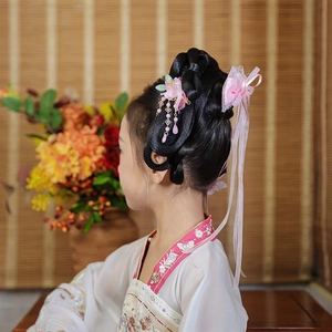 Detail of pink silk flowers and hanging tassels on traditional Chinese hair stick