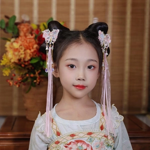 Detailed close-up of pink butterfly hair clips with long tassels and pearls for Hanfu costumes