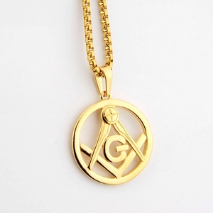 Macro shot of gold Masonic square and compass pendant on a matching box chain