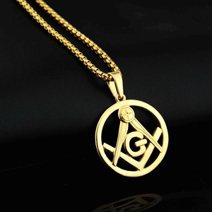 Gold Freemasonry circular pendant necklace with G symbol on black leather background