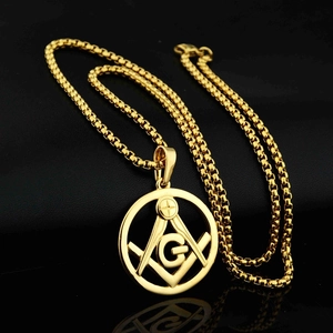 Detailed macro view of golden Masonic Freemason symbol pendant with thick box chain