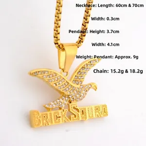 Macro shot of gold hip hop eagle pendant with crystal inlay and BRICK SQUAD letter detail