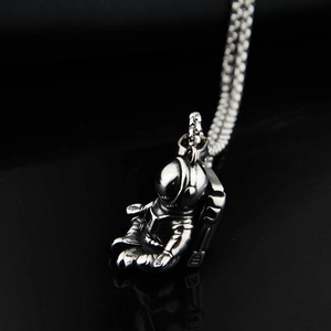 Close-up of hip hop astronaut pendant with vintage finish on titanium steel chain