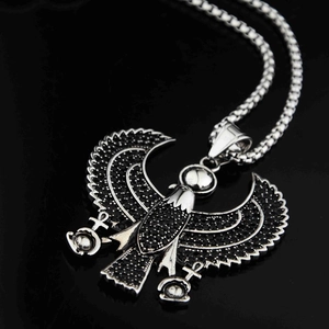 Détail macro du pendentif aigle Horus avec zircons noirs et symboles Ankh égyptiens