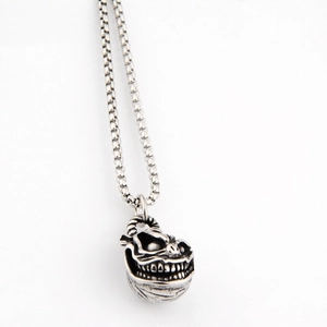Close-up of vintage silver ghost pendant with box chain and punk gothic style details