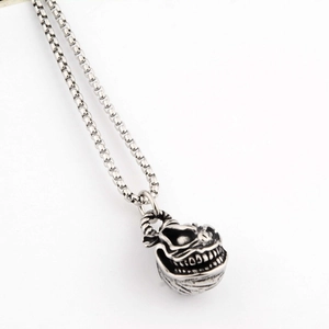 Macro shot of the punk smile demon pendant detail with antique finish and box chain