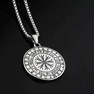 Macro shot of silver stainless steel Viking Vegvisir compass pendant with Runes engraving